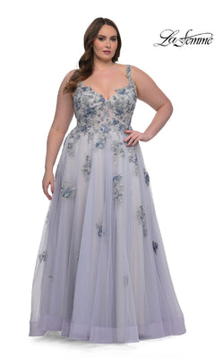 A woman faces forward in the La Femme 32412, a sleeveless, floor-length lavender plus-size prom ball gown with lace embroidery and corset bodice. The "La Femme" logo appears in the top right corner.