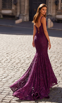 A woman stuns in the La Femme 32420 long lace mermaid prom dress, elegantly showcasing a purple formal gown.