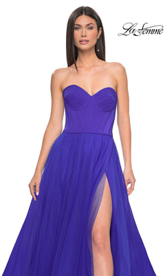 A woman wears the Strapless Long Tulle Prom Dress: La Femme 32424 in royal blue, featuring a sweetheart neckline, corset-style bodice, and high slit skirt. The "La Femme" logo is shown in the top right corner.