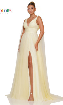 A woman wearing the Classic Long Prom Ball Gown: Colors Dress 3242, a sleeveless, floor-length pale yellow dress with a deep V-neckline, high slit, and sheer cape panels, stands against a white background.