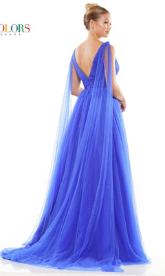 A woman stands against a white background in the Classic Long Prom Ball Gown: Colors Dress 3242, a royal blue floor-length evening gown featuring a v-neck, deep V-back, and sheer flowing cape sleeves.