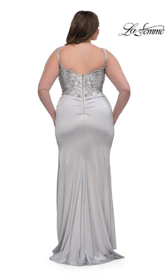 A woman is shown from the back wearing the Plus-Size Long Satin Prom Dress La Femme 32430—a silver gown with thin straps and a rhinestone beaded bodice. The La Femme logo appears in the top right corner.