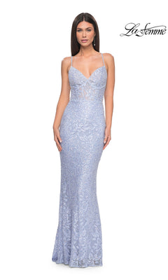 Woman in a long periwinkle lace prom dress (La Femme 32434) with spaghetti straps, fitted silhouette, subtle sheer detailing; "La Femme" logo appears in the top right corner.