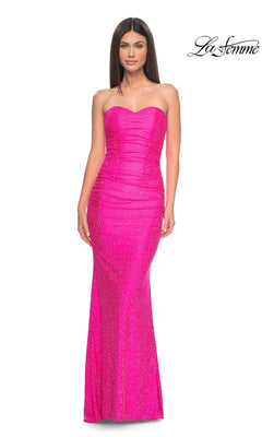 A woman poses in the Neon Pink Strapless Long Prom Dress, La Femme 32436—a fitted, floor-length gown with subtle sparkle. The La Femme logo is displayed in the top right corner.