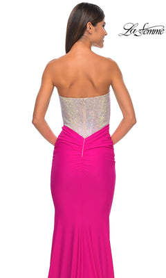 A woman is seen from the back against a white background wearing the Strapless Hot Pink Long Prom Dress La Femme 32440, featuring a form-fitting floor-length skirt and sparkling silver bodice.