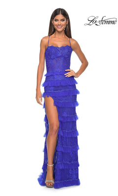 A woman wears the Ruffled Long Beaded-Lace Prom Dress (La Femme 32442), a vibrant blue, sleeveless gown with ruffles and a high slit, standing against a white background, with the La Femme 32442 logo in the top right corner.