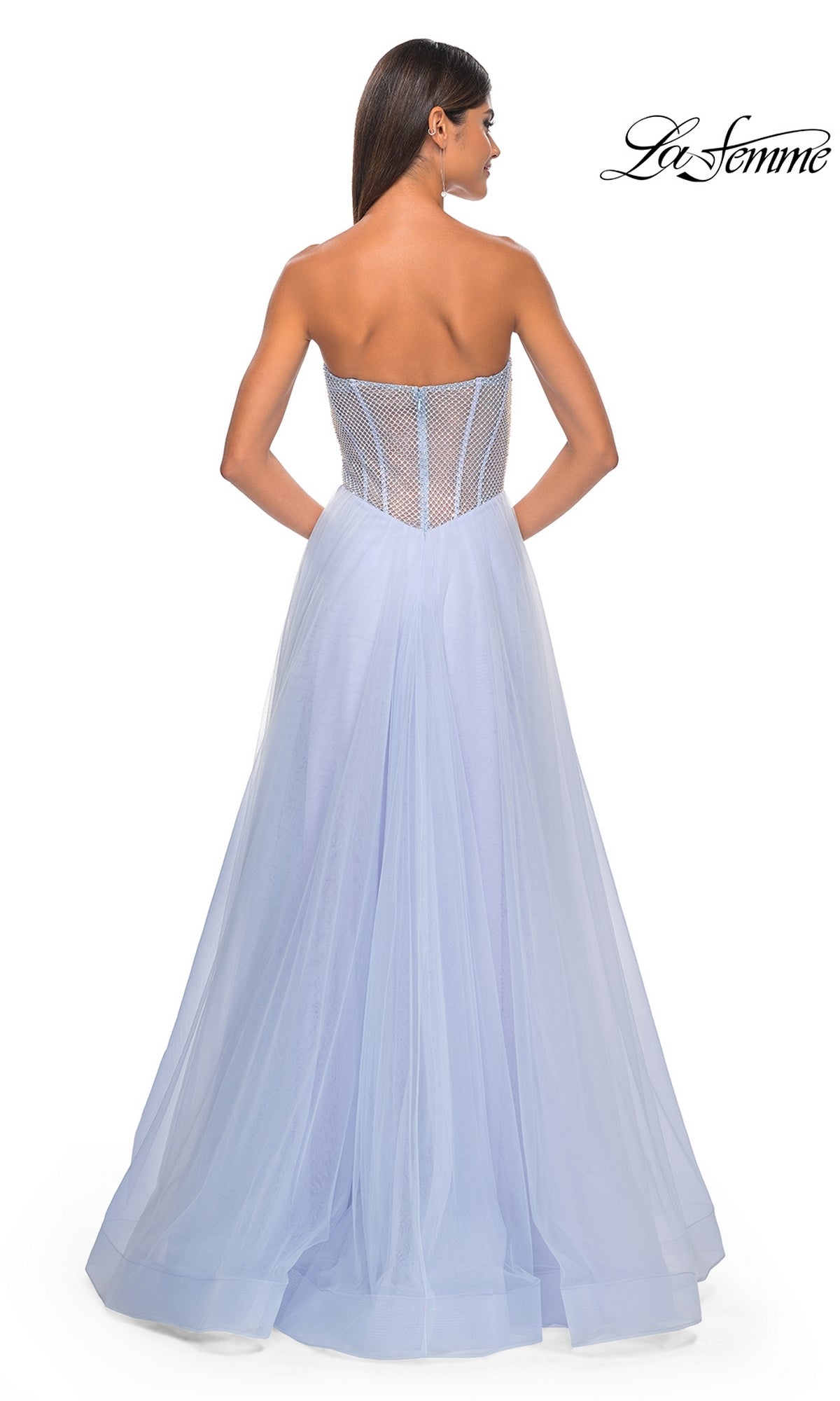A woman wears the Strapless Long A-Line Prom Dress: La Femme 32445 in light blue with a sheer corset-style bodice, standing facing away. The La Femme logo is displayed in the top right corner.