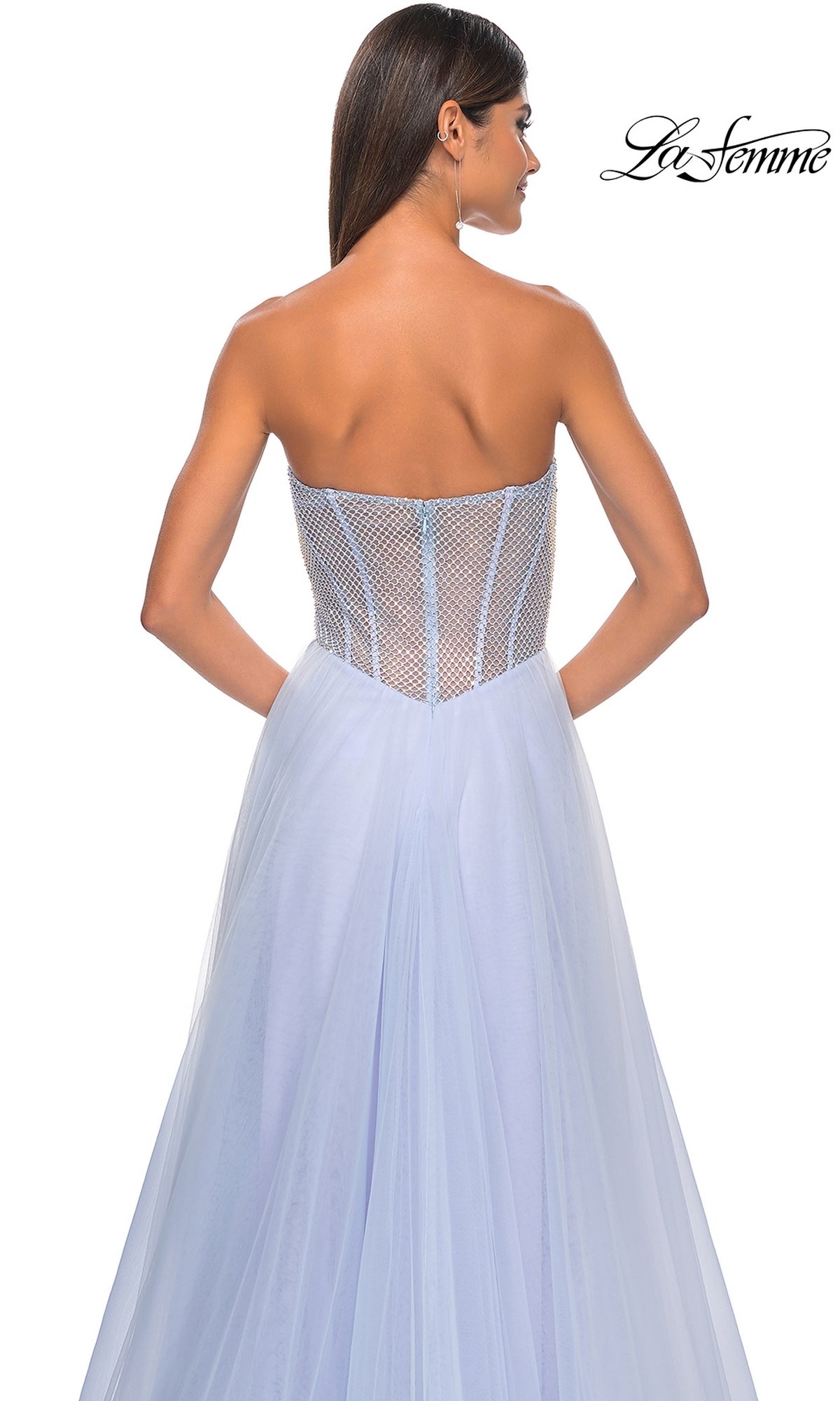 A woman is shown from the back wearing the La Femme 32445 Strapless Long A-Line Prom Dress, featuring a sheer corset-style bodice and flowing tulle skirt. The 