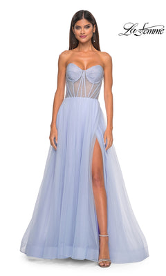 A woman wears the La Femme 32445 strapless long A-line prom dress in light periwinkle, featuring a sheer corset-style bodice and high slit, standing against a white background.