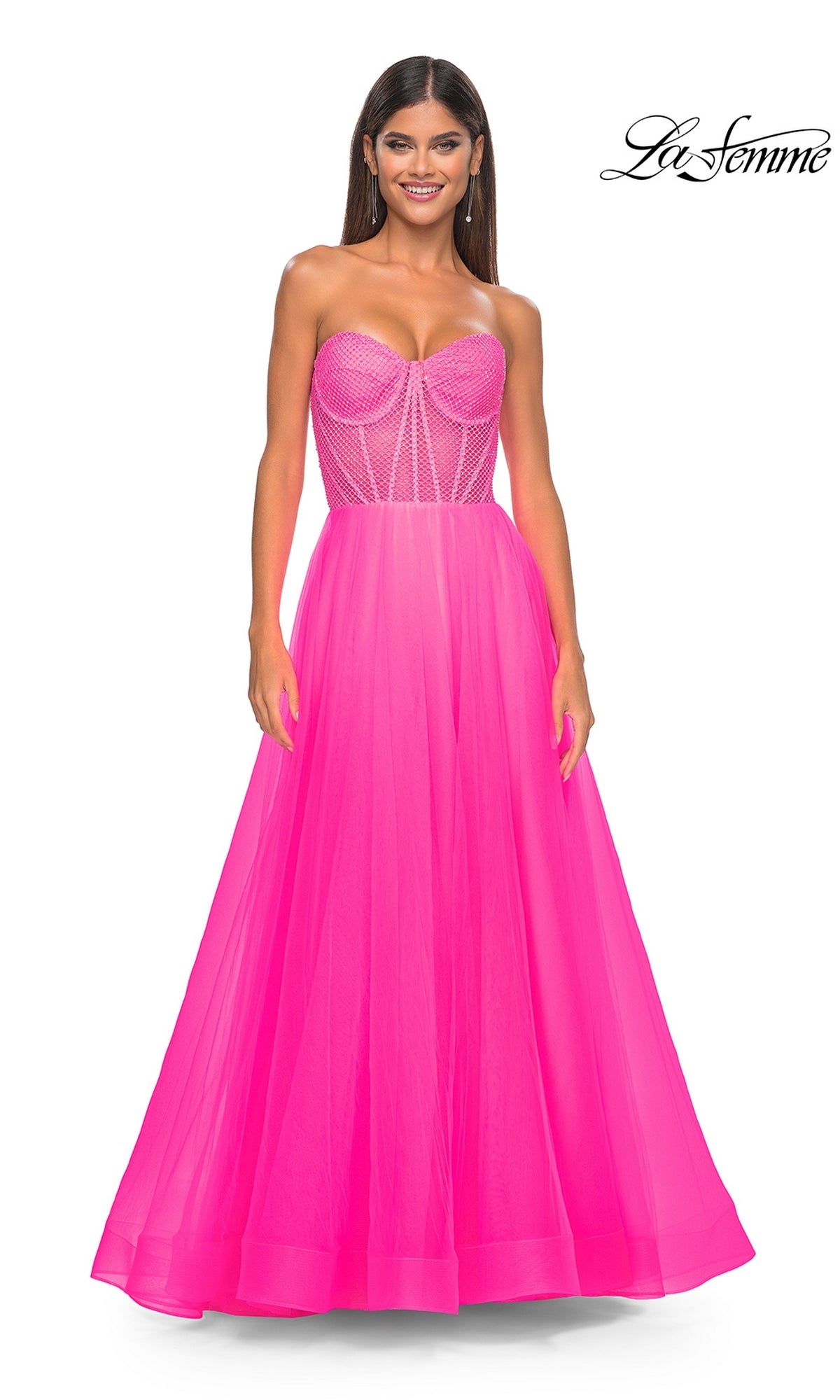 A woman models the La Femme 32445, a strapless long A-line prom dress with a corset-style embellished bodice and flowing tulle skirt, standing against a plain white background.