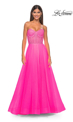 A woman models the La Femme 32445, a strapless long A-line prom dress with a corset-style embellished bodice and flowing tulle skirt, standing against a plain white background.