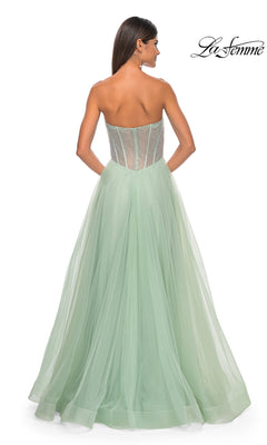 A woman is seen from the back wearing La Femme 32445, a strapless long A-line prom dress in mint green with a sheer corset-style bodice and flowing tulle skirt. La Femme logo appears in the top right corner.
