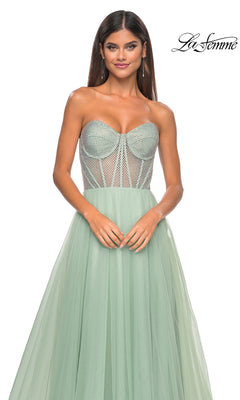A woman models the La Femme 32445, a strapless long A-line mint green tulle prom dress with a corset-style embellished bodice and sheer paneling; “La Femme” logo displayed top right.