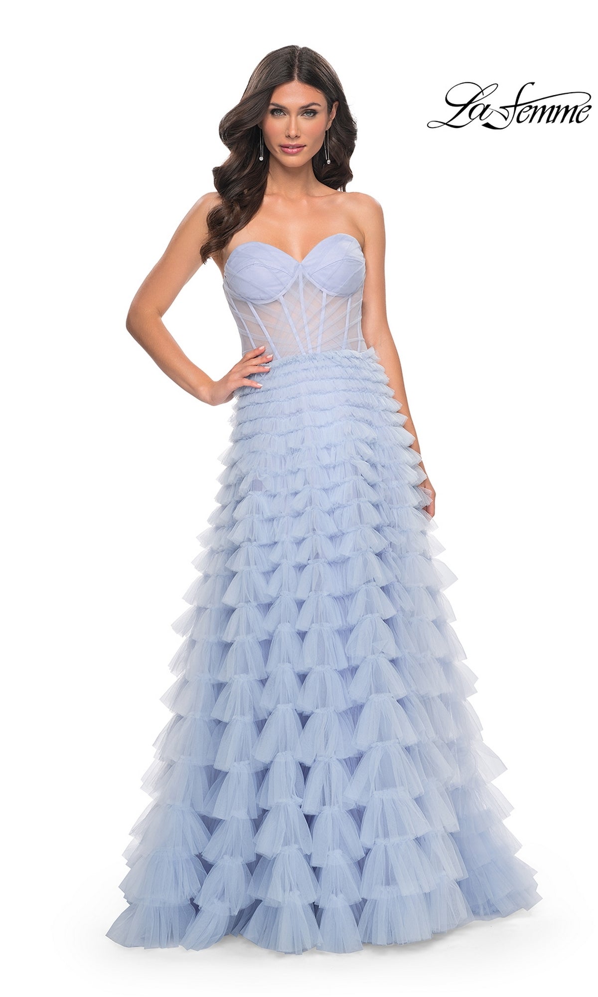 A woman models the La Femme 32447 Long Ruffled A-Line Prom Ball Gown—strapless, light blue, with a fitted bodice and tiered tulle skirt—against a white background. The La Femme logo is in the top right corner.