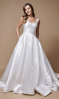A woman in the Nina Canacci 3251 long formal dress, featuring a sleeveless satin design and elegant A-line silhouette, stands against a plain beige background.