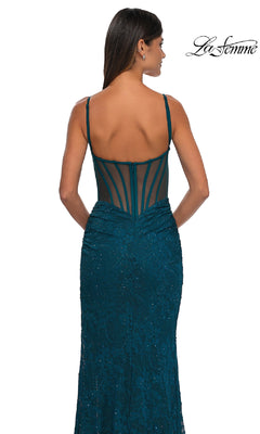 Woman in a La Femme 32529 Sheer-Sides Long Beaded Prom Dress, featuring teal color, floor length, and spaghetti straps, poses against a white background.