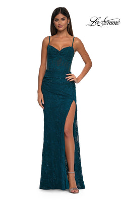 A woman models the Sheer-Sides Long Beaded Prom Dress: La Femme 32529, featuring a teal beaded lace design with spaghetti straps, sweetheart neckline, and thigh-high slit, paired with silver heels against a white background.