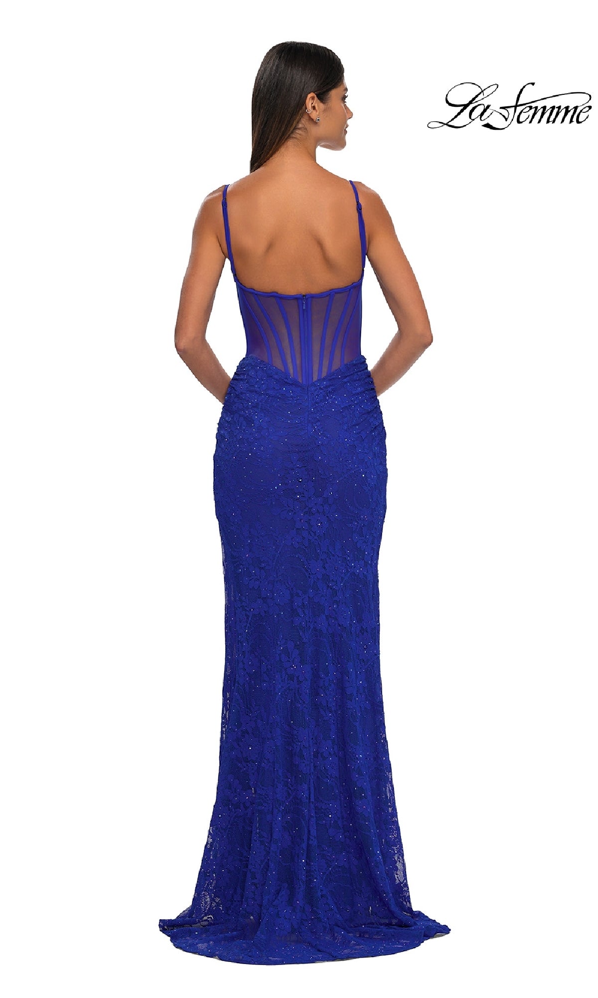 A woman is shown from the back wearing the Sheer-Sides Long Beaded Prom Dress (La Femme 32529), a fitted, floor-length royal blue gown with thin straps, sheer structured bodice, and lace beadwork. The La Femme logo is in the top right corner.