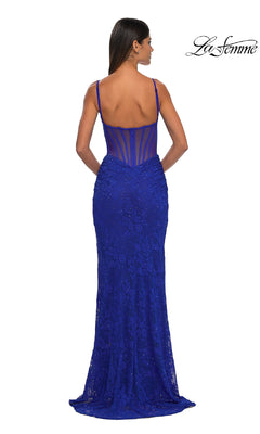 A woman is shown from the back wearing the Sheer-Sides Long Beaded Prom Dress (La Femme 32529), a fitted, floor-length royal blue gown with thin straps, sheer structured bodice, and lace beadwork. The La Femme logo is in the top right corner.