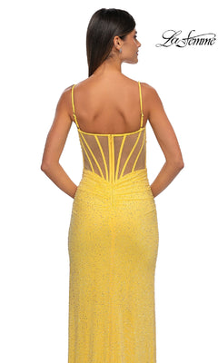 A woman is seen from behind wearing the La Femme 32578 long beaded prom dress in yellow, featuring thin straps and a sheer-back panel. The sparkling gown exudes elegance, with "La Femme" displayed in the top right corner.