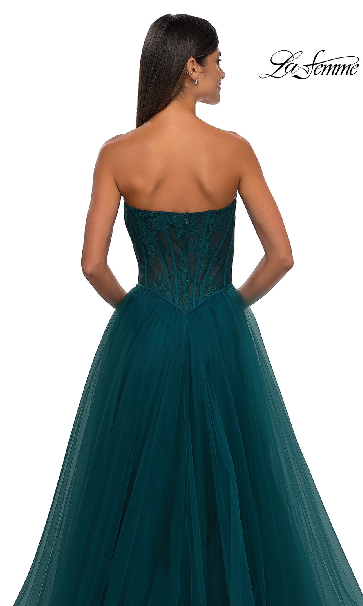 Woman in the La Femme 32579 Strapless Long Prom Ball Gown, featuring a floral corset bodice with lace accents and a flowing tulle skirt, elegantly posed to show the back view.