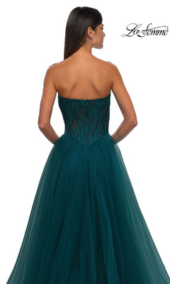 Woman in the La Femme 32579 Strapless Long Prom Ball Gown, featuring a floral corset bodice with lace accents and a flowing tulle skirt, elegantly posed to show the back view.