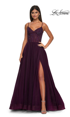 A woman wears the Beaded-Bodice Long Prom Ball Gown: La Femme 32594—floor-length, deep purple, with spaghetti straps, a beaded bodice, and a high side slit—standing against a plain white background.