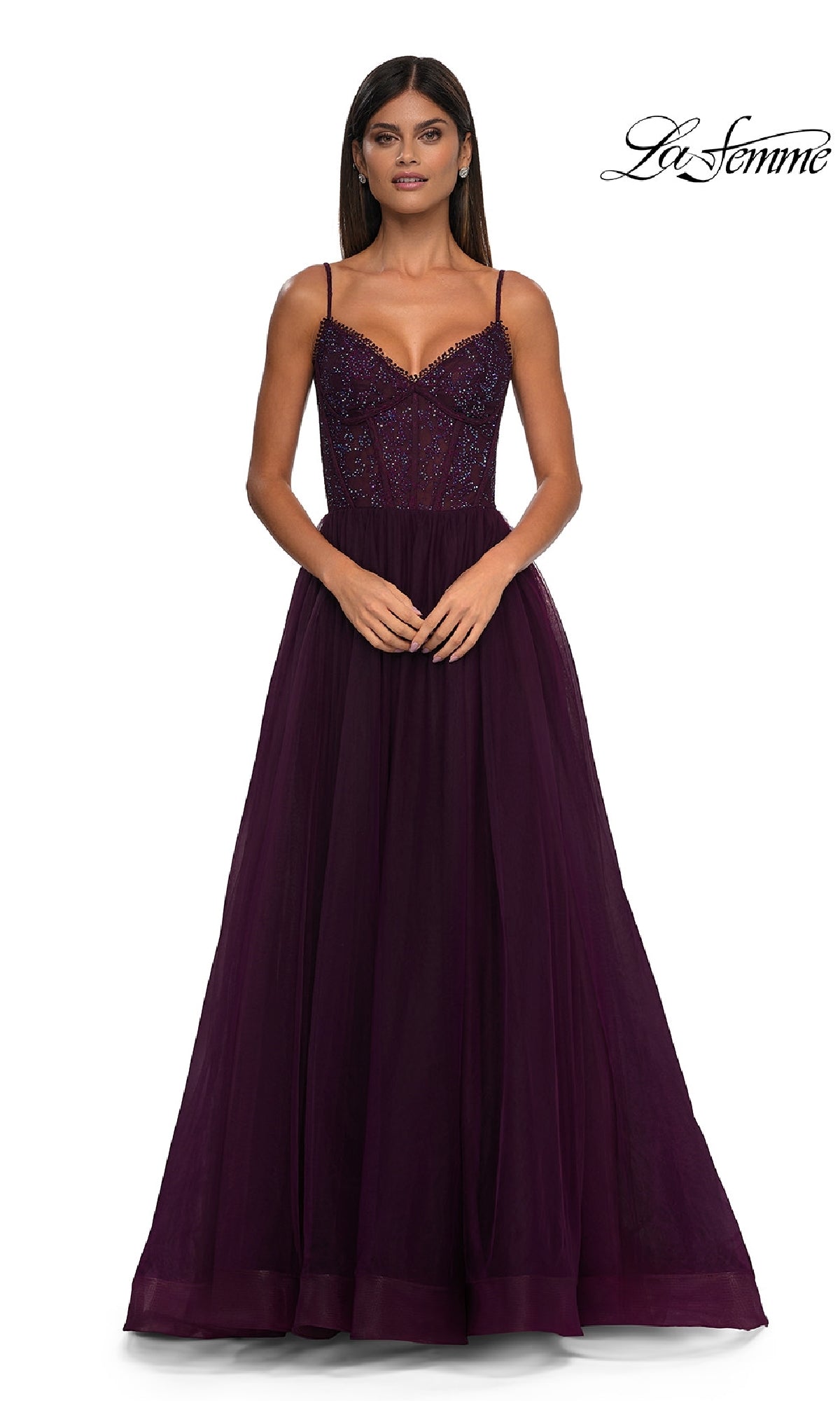 Woman wearing the Beaded-Bodice Long Prom Ball Gown: La Femme 32594, a floor-length deep purple dress with thin straps and a beaded bodice, standing with hands clasped; La Femme logo appears in the top right corner.