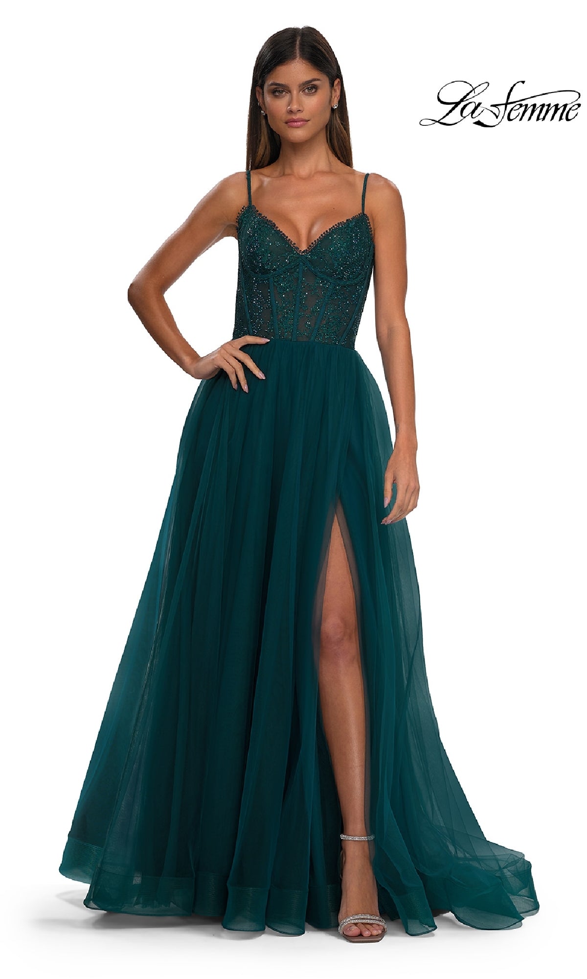 A woman models the La Femme 32594 Beaded-Bodice Long Prom Ball Gown, featuring a sleeveless dark teal design with a fitted beaded bodice, sheer paneling, and a thigh-high slit against a white background.