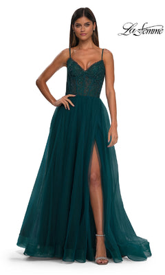A woman models the La Femme 32594 Beaded-Bodice Long Prom Ball Gown, featuring a sleeveless dark teal design with a fitted beaded bodice, sheer paneling, and a thigh-high slit against a white background.