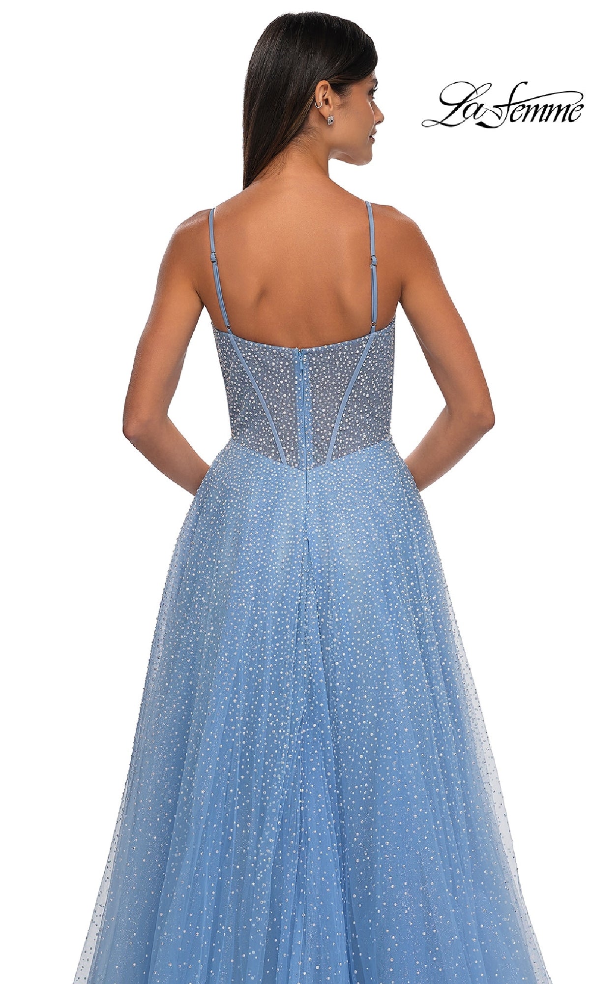 A woman with long dark hair is shown from the back wearing the La Femme 32644 Pearl Classic Long Prom Dress—a blue, sparkly, sleeveless A-line gown with thin straps—against a white background.