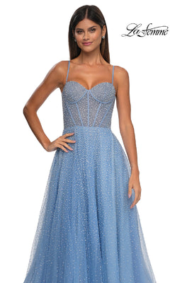 A woman models the Pearl Classic Long Prom Dress: La Femme 32644, a light blue, pearl-beaded A-line gown with thin straps and a fitted corset bodice, standing against a white background.