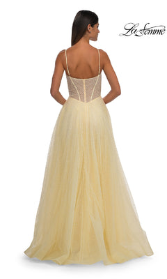 A woman is shown from the back wearing the Pearl Classic Long Prom Dress: La Femme 32644, a light yellow, pearl-beaded prom dress with spaghetti straps and a sheer bodice. The La Femme logo is in the top right corner.