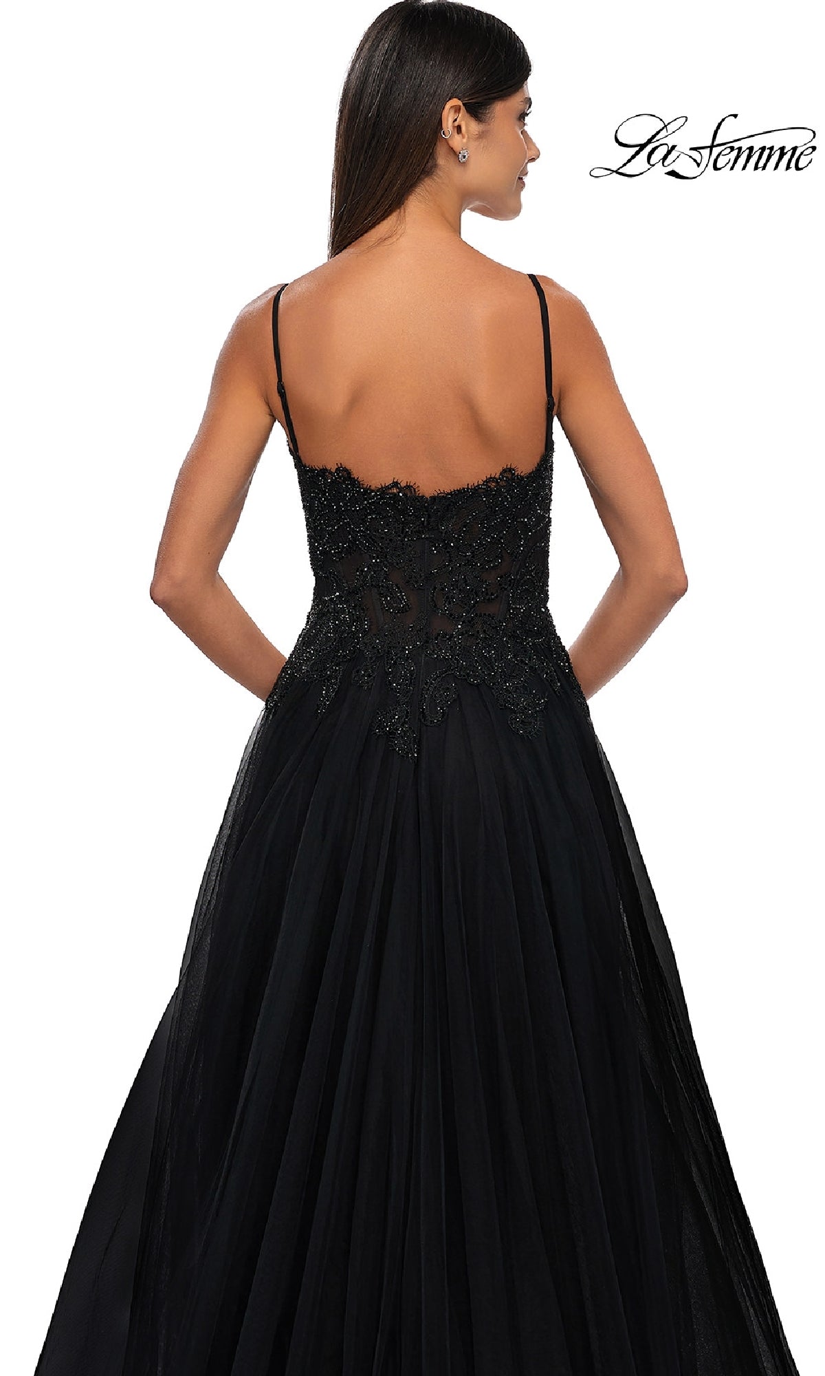 Woman wearing the Long Prom Ball Gown with Pockets: La Femme 32646—black, floor-length, sleeveless with thin straps and lace detail—shown from the back. 