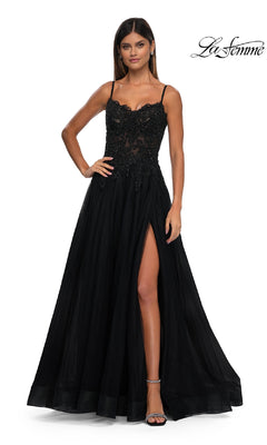 A woman wears a sleeveless black La Femme 32646 long prom ball gown with pockets, standing against a white background. The La Femme logo is displayed in the top right corner.