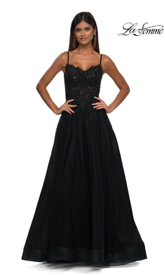A woman stands facing forward in the Long Prom Ball Gown with Pockets: La Femme 32646, featuring a sleeveless black lace bodice and full tulle skirt, against a plain white background. The "La Femme" logo appears in the top right corner.