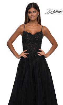Woman in a sleeveless black beaded floral dress with lace details stands with hands on hips against a white background. The "La Femme" logo appears, highlighting the Long Prom Ball Gown with Pockets: La Femme 32646.