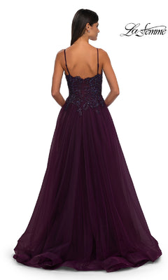 A woman is shown from the back in the La Femme 32646, a long prom ball gown with pockets. The deep purple dress features spaghetti straps, a beaded bodice, and a flowing tulle A-line skirt for a stunning silhouette.