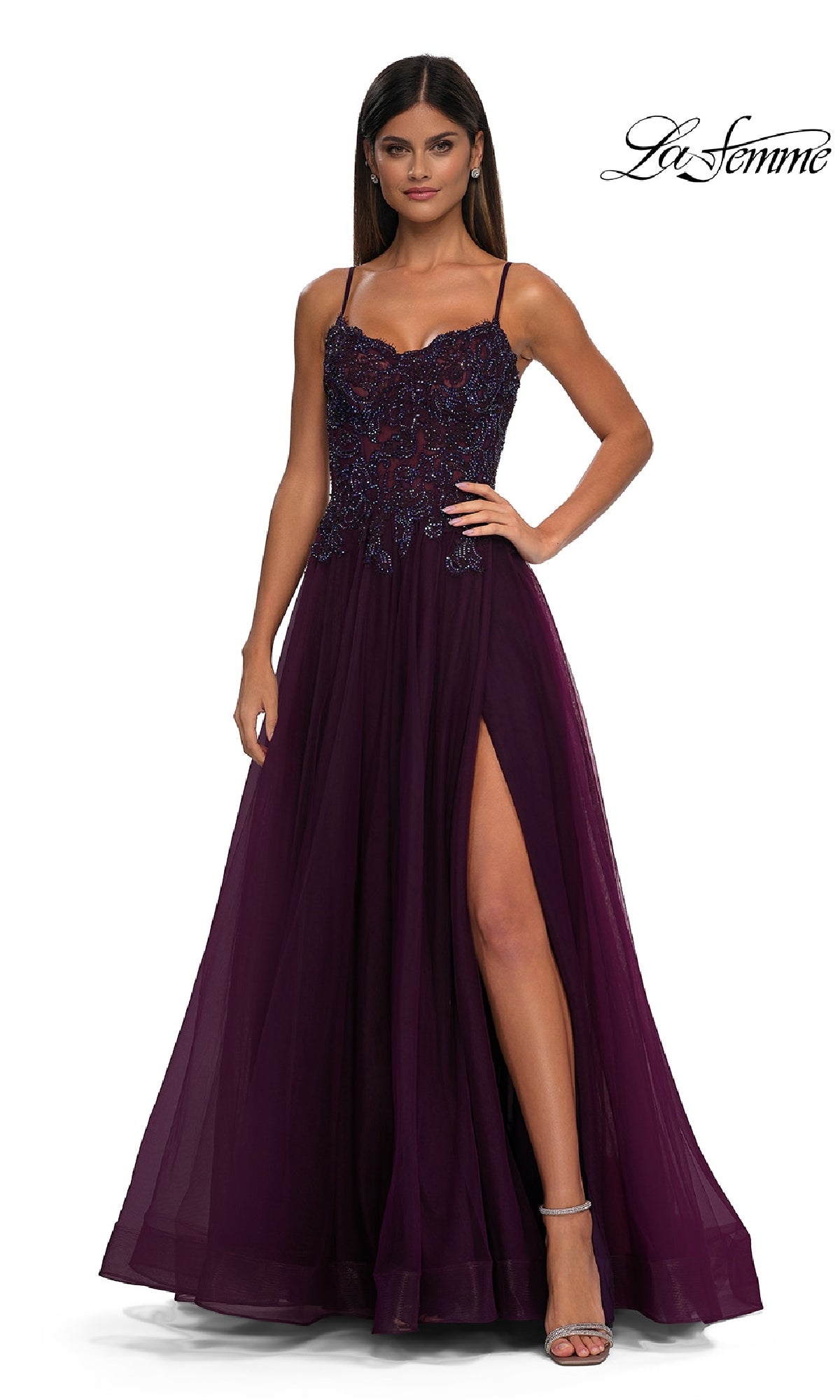 Woman wearing the La Femme 32646 long prom ball gown with pockets, featuring a sleeveless design, beaded bodice, and high slit, standing against a white background.