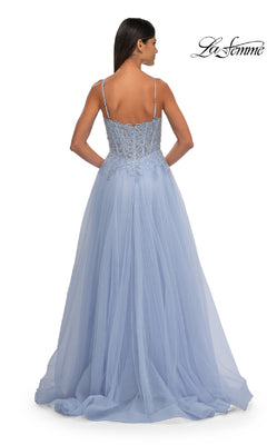 A woman is seen from behind in the La Femme 32646 Long Prom Ball Gown with Pockets, featuring thin straps, lace bodice detailing, and a flowing light blue tulle skirt—perfect for making an entrance at any event.