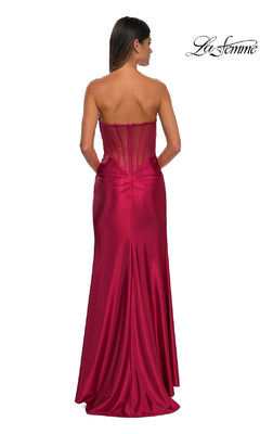 A woman is photographed from behind in the La Femme 32649 Sheer-Back Strapless Prom Gown, featuring a sweetheart neckline, sheer back panel, and elegant ruching, set against a white background.