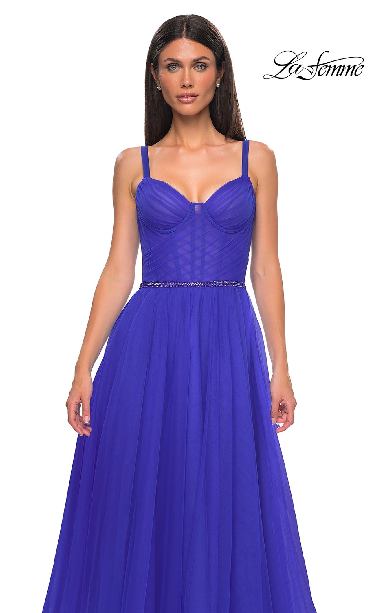 A woman wears the La Femme 32956 Beaded-Waist Long Prom Ball Gown in royal blue, featuring an A-line silhouette with a fitted bodice, flowing skirt, and elegant beaded waist detail, standing against a plain white background.