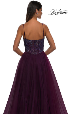 Woman in a deep purple, floor-length a-line prom dress (La Femme 32668) with a beaded v-neck bodice and thin straps, shown from behind. "La Femme" logo appears in the top right corner.
