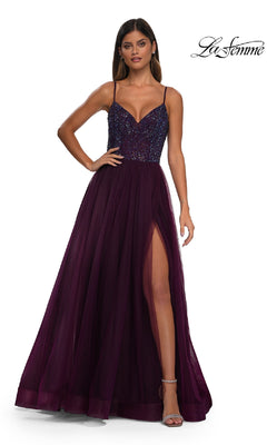 A woman wears the La Femme 32668 Beaded-Bodice Long Prom Ball Gown, featuring a deep purple a-line silhouette, beaded v-neck bodice, spaghetti straps, and high slit. The La Femme logo appears in the top right corner.