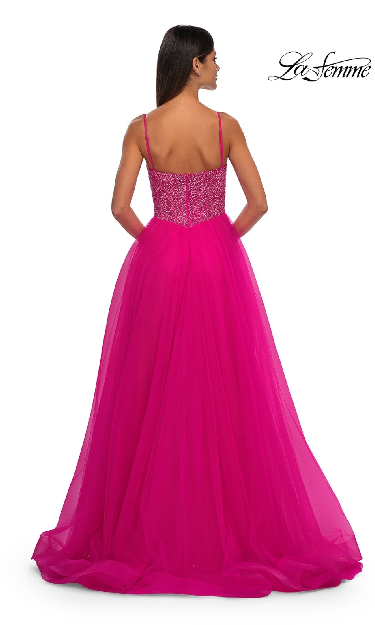 Woman modeling the Beaded-Bodice Long Prom Ball Gown La Femme 32668 in vibrant pink, featuring thin straps and a beaded v-neck bodice, shown from the back against a plain white background.