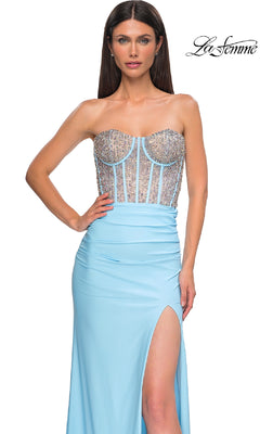 A woman models the La Femme 32669 strapless long corset prom dress, featuring a beaded sheer bodice and high slit, against a white background.