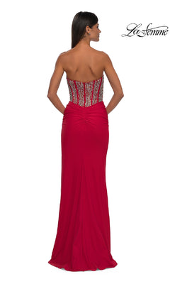A woman poses with her back to the camera in the Strapless Long Corset Prom Dress: La Femme 32669, featuring a beaded corset bodice and ruched detailing. "La Femme" logo appears in the top right corner.