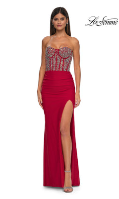 A woman stands against a plain background wearing the La Femme 32669 Strapless Long Corset Prom Dress, featuring a beaded corset-style bodice and high slit.