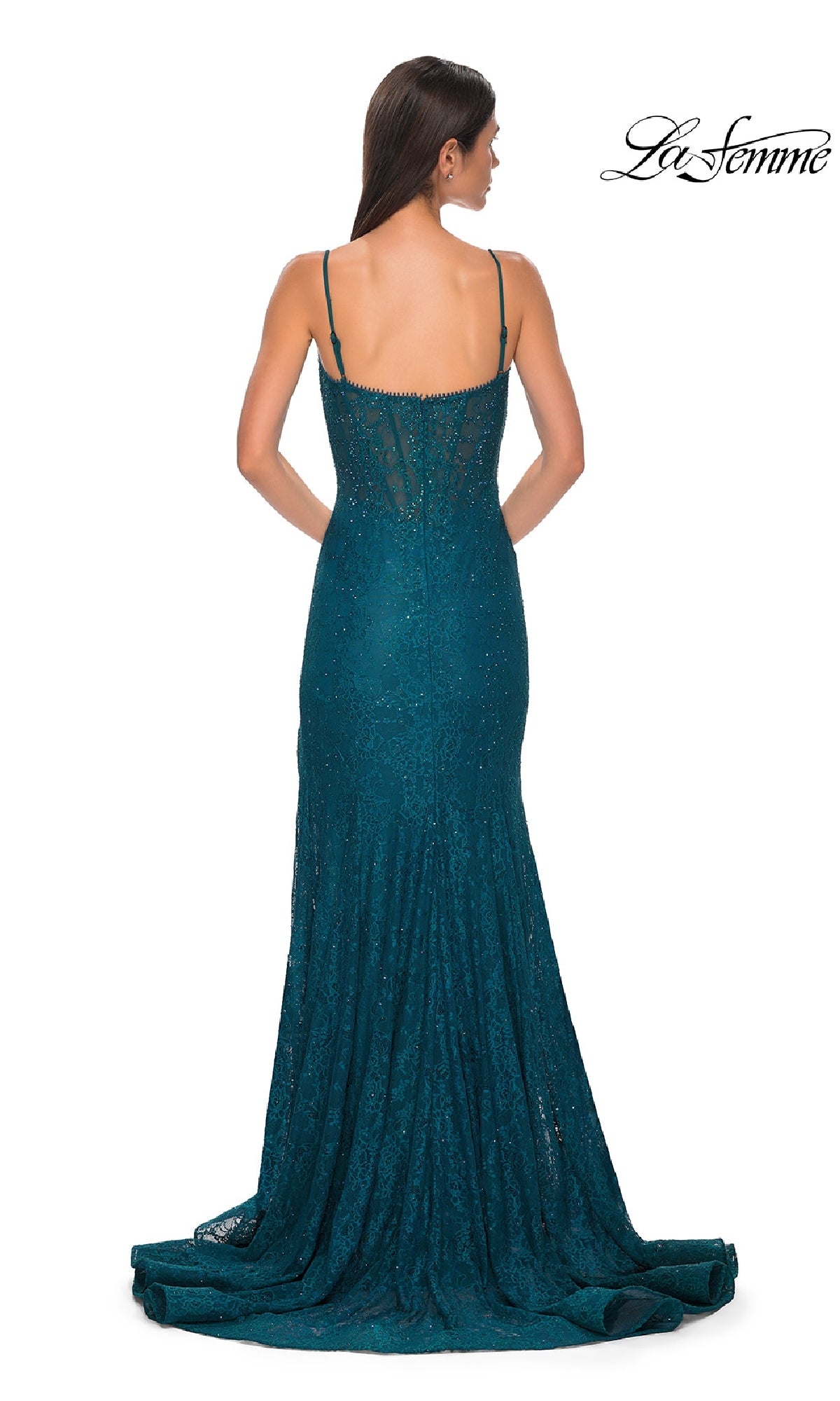 A woman stands with her back to the camera in the Beaded-Lace Long Corset Prom Dress: La Femme 32671, featuring teal lace, thin straps, and a train. The “La Femme” brand name appears in the top right corner.
