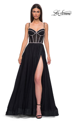 A woman models the La Femme 32675 Long Corset Prom Ball Gown in black, featuring a sheer corset bodice, spaghetti straps, and a high thigh slit against a white background.